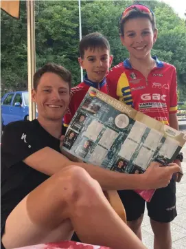  ??  ?? Sam Bennett signs his Giro sticker for two young fans during yesterday’s Giro d’Italia rest day in Bergamo