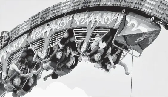  ?? AMY DAVIS/BALTIMORE SUN PHOTOS ?? Riders on the Fire Ball get a different perspectiv­e of the Maryland State Fair. Today, Labor Day, is the last day for this year’s fair.