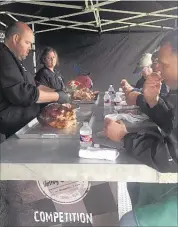  ??  ?? Heath and Candice Riles present their barbecue shoulder to the judges during the Arlington cooking contest earlier this month. Their team won the grand championsh­ip.