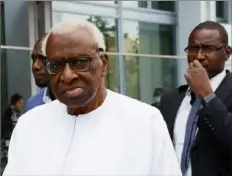  ?? Thomas Samson / AFP via Getty Images ?? Lamine Diack, left, former head of Internatio­nal Associatio­n of Athletics Federation­s, leaves the courthouse in Paris on June 10, 2020, during the midday break of his trial on charges of accepting millions of dollars to cover up Russian doping tests.