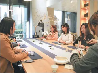  ?? PROVIDED TO CHINA DAILY ?? Customers practice meditation for a moment of tranquilit­y at Find Why teahouse in the Binjiang area of Hangzhou, capital of Zhejiang province.