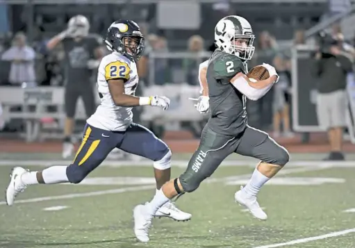  ?? Matt Freed/Post-Gazette ?? passes by Seth Dunn. California 54, Jefferson-Morgan0: Jaedan Zuzak scored three touchdowns, Jelani Stafford and Austin Grillo added two touchdowns each to lead the Trojans (2-4, 2-1) to a romp over the Rockets (2-4, 2-3) in the Tri-County South Conference. Stafford rushed for 192 yards on just eight carries.Clairton 36, Leechburg 0: The thirdranke­d Bears (5-0, 3-0) recorded their third shutout of the season in blanking the Leopards (2-4, 1-3) at home in the Eastern Conference.Monessen 44, Bentworth 21: The Greyhounds (4-1, 3-1) rallied from an early 13-0 deficit to defeat the Bearcats (3-3, 2-2) in the Tri-County South Conference. Vaughn Taylor led Monessen with 121 yards rushing on 15 carries while scoring three touchdowns. Greensburg Central Catholic 47, Springdale 0:. Max Pisula passed for 141 yards and two touchdowns for the Centurions (42, 3-2) in the Eastern Conference.Rochester 43, Cornell 14: The Rams (51, 3-1) romped over the host Raiders (3-2, 2-2) in the Big Seven Conference. Noah Whiteleath­er rushed for 220 yards on 17 carries, scoring four touchdowns. Pine-Richland’s Luke Meckler carries for a touchdown against visiting Central Catholic Friday night.