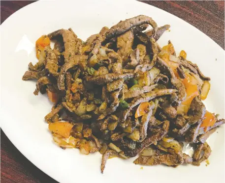 ?? PHOTOS: PETER HUM ?? Fried lamb meat is one of the spicier Yemeni meals on the menu at Bukhari Restaurant on Carling Avenue.