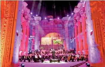  ?? — AFP photo ?? Maestro Harout Fazlian conducts rehearsals ahead of the Sound of Resilience concert inside the Temple of Bacchus at the historic site of Baalbek in Lebanon’s eastern Bekaa Valley.