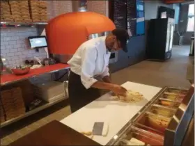  ?? DONNA ROVINS - MEDIANEWS GROUP PHOTO ?? Derrick Teel, kitchen lead at Sly Fox Brewing Co. prepares a pizza during an event June 12 for invited guests at the new Sly Fox Taphouse in Wyomissing, Berks County. The company’s newest location opened June 16.