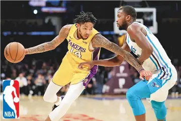  ??  ?? Brandon Ingram #14 of the Los Angeles Lakers drives into a defending Michael Kidd-Gilchrist #14 of the Charlotte Hornets during the second half of a game at Staples Center on January 5, 2018 in Los Angeles, California. NOTE TO USER: User expressly...