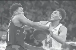  ?? FRANK FRANKLIN II/AP ?? Toronto Raptors’ Kyle Lowry, left, defends New York Knicks’ Allonzo Trier, right, during the second half of Saturday’s game in New York. The Raptors won 104-99.