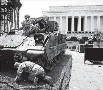  ?? MARK WILSON/GETTY ?? Soldiers prepare an armored vehicle Wednesday for display near the Lincoln Memorial ahead of Thursday’s celebratio­n.