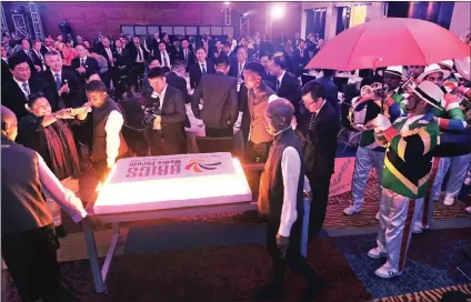  ?? Picture: Ian Landsberg/African News Agency (ANA) ?? WORKING TOGETHER: Members of the 7 Steps Minstrels troupe sing Happy Birthday as the BRICS Media Forum birthday cake for Nelson Mandela’s centenary is wheeled into the venue where the welcome Gala Dinner for delegates to the 3rd BRICS Media Forum...