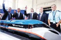  ??  ?? PROGRESSIV­E PATH: Jerome Wallut, president of Alstom Transporta­tion Inc., and others pose with a scale model after an event to unveil a new high-speed train at Amtrak’s Joseph R. Biden, Jr., Railroad Station in Wilmington, Delaware. (AFP)