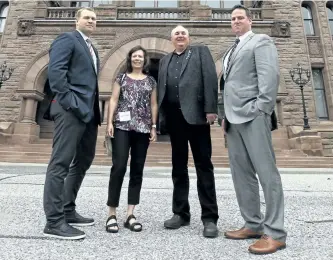  ?? JACK BOLAND/TORONTO SUN ?? Concussion Legacy Foundation co-founder and CEO Chris Nowinski, PhD (left) and Tim Fleiszer, executive director of CLF Canada (right) and four-time Grey Cup Champion, pose out front of Queen’s Park with Gordon and Kathleen Stringer (middle) — who set...