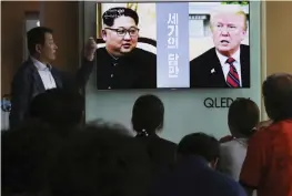  ?? — AP ?? People watch a TV screen showing file footage of US President Donald Trump ( right) and North Korean leader Kim Jong Un during a news programme at the railway station in Seoul.