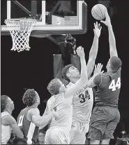  ?? AP/KATHY WILLENS ?? Penn State forward Julian Moore (44) shoots over Texas A&M’s D.J. Hogg (1) and Tyler Davis (34) during the Aggies’ 98-87 victory in the Legends Classic in New York.