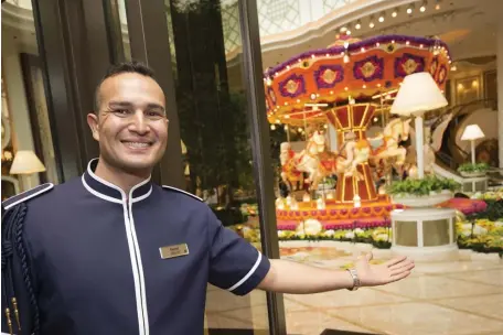  ?? NICOLAUS CZARNECKI PHOTOS / HERALD STAFF FILE ?? BE OUR GUEST: Doorman Kamal Nadir welcomes guests to Encore Boston Harbor in Everett on the casino’s opening day, June 21. The casino has hired more than 5,000 people.