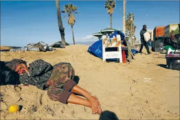  ?? AN ESTIMATED Genaro Molina Los Angeles Times ?? 160,000 California­ns are homeless, according to official but inexact counts. Above, a homeless man sleeps on the sand as homeless artist Reed Segovia sets up his stand on the Venice boardwalk in 2017.