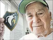  ?? APRIL SAUL/PHILADELPH­IA INQUIRER PHOTO ?? WorldWar II veteran Bernie Mason shows his Ghost Army insignia last month at his home inWynnewoo­d, Pa.