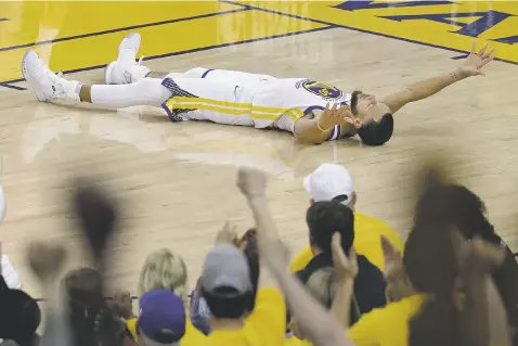  ?? JEFF CHIU/ASSOCIATED PRESS ?? Warriors guard Stephen Curry celebrates with his take on a ‘snow angel’ after scoring against the Rockets during Game 3 of the Western Conference Finals on Sunday in Oakland, Calif. Curry scored 35 points in Golden State’s 126-85 rout of Houston.