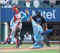  ?? Jeffrey McWhorter / Associated Press ?? The Rangers’ Isiah Kiner-Falefa scores on a go-ahead RBI-single by Brock Holt as home plate umpire Brian O’Nora and Red Sox catcher Kevin Plawecki look on during the eighth inning on Sunday in Arlington, Texas.