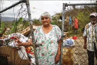  ?? PHOTOS BY MARIO TAMA / GETTY IMAGES ?? Luz Sota Rivera and Francisco Nazario Aviles stand outside their damaged home next to uncollecte­d debris Thursday in Jayuya, Puerto Rico. South Florida emergency responders say that exasperati­ng island politics and bureaucrac­y have made their relief...