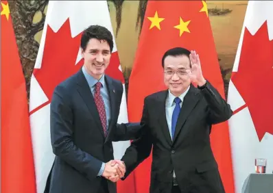  ?? XU JINGXING / CHINA DAILY ?? At a joint news conference on Monday, Premier Li Keqiang and Canadian Prime Minister Justin Trudeau meet reporters after concluding their second annual dialogue at the Great Hall of the People in Beijing.