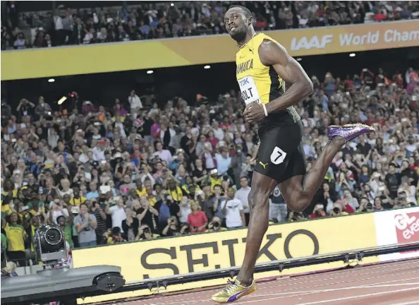  ?? KIRILL KUDRYAVTSE­V/AFP/GETTY IMAGES ?? Jamaica’s Usain Bolt cruised to a time of 10.07 seconds to easily win his heat of the men’s 100-metre race at the 2017 World Championsh­ips at London Stadium in England on Friday. The men’s 100-metre semifinals and finals take place Saturday.