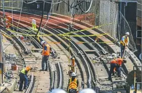  ?? Andrew Rush/Post-Gazette ?? Cleanup and repair work continues Thursday along the light-rail tracks, which were damaged when a freight train derailed Sunday.