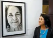  ?? DAMIAN DOVARGANES — THE ASSOCIATED PRESS FILE ?? In this file photo, Dolores Huerta, co-founder of United Farms Workers stands by a portrait of herself taken in 1998 by photograph­er Angela Torres, as she tours her exhibition, “Viva la Causa! Dolores Huerta and the Struggle for Justice,” at La Plaza...