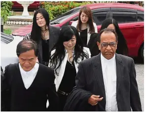  ??  ?? Day in court: Phang (centre) arriving with her lawyers at the Penang High Court in George Town. (Left) Lim’s counsels Ramkarpal and Rayer outside the courthouse.