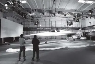  ??  ?? Ben Krall, left, and his brother Josh check out a large model of the XB-1 Supersonic Demonstrat­or jet at Boom Technology at Centennial Airport last month. The company has been building a supersonic jet that goes Mach 2.2 and is slated for its first...