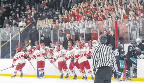  ?? DAVID JALA/CAPE BRETON POST ?? Riverview Redmen players celebrate their first goal of the Red Cup championsh­ip game that was played against Cole Harbour’s Auburn Eagles before a full house at the County Recreation Centre in Coxheath on Sunday. Goal scorer Carter Harnish (No. 11) leads the procession as he and his linemates skate past the Redmen bench while fans cheer them on from the stands. In the end, the hosts overcame a 3-2 third period deficit on a pair of Andrew McCarron goals to claim their first Red Cup title since 2013. McCarron, who was the tournament’s leading scorer, was named the first star of the championsh­ip game. McCarron and Riverview captain Dylan MacDonald shared the tournament’s most valuable player award. Redmen goalie Michael MacMullen was named the tournament’s top goalie. More coverage on