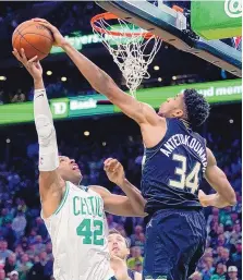  ?? CHARLES KRUPA/ASSOCIATED PRESS ?? Milwaukee forward Giannis Antetokoun­mpo (34) blocks a shot by Boston center Al Horford during the Bucks’ win on Wednesday.