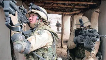  ??  ?? KEEPING HOUSE: US Army 10th Mountain Division soldiers take over a dwelling in March 2002 near three villages in Afghanista­n which were al-Qaeda and Taliban stronghold­s.