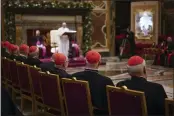  ?? ANDREW MEDICHINI — THE ASSOCIATED PRESS FILE ?? Cardinals listen as Pope Francis, background, delivers his Christmas greetings to the Roman Curia in the Clementine Hall at the Vatican. Francis has ordered pay cuts for Holy See employees.