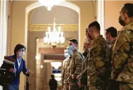  ?? Anna Moneymaker / New York Times ?? Sen. Susan Collins, R-Maine, speaks to National Guard troops during a break in the Senate impeachmen­t trial of former President Donald Trump on Thursday.