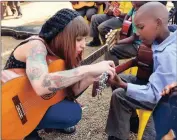  ?? Picture: BOXER NGWENYA ?? STIMULATIN­G: Kelly Grevler giving guitar lessons to children who attend the Lerato Education centre in Eikenhoff, south of Johannesbu­rg.