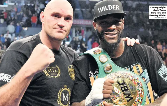 ?? Lionel Hahn/AP ?? Heavyweigh­trivals Tyson Fury, left, and Deontay Wilder