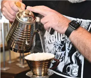  ?? The Sentinel-Record/Tanner Newton ?? ■ Kevin Rogers, owner of Kollective Coffee + Tea, makes some coffee at the shop.