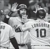  ?? HAYNE PALMOUR IV/TRIBUNE NEWS SERVICE ?? The Giants' Brandon Belt, middle, and Donovan Solano (7) celebrate a three-run home run by Evan Longoria (10) against the Padres in San Diego on July 2, 2019.