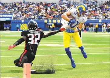  ?? COOPER KUPP Wally Skalij Los Angeles Times ?? makes a move against Falcons safety Jaylinn Hawkins to score in the third quarter.