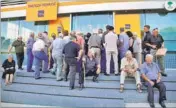  ?? REUTERS ?? People wait to enter a Piraeus Bank branch after banks reopened after a three-week shut down, in Crete, Greece, on Monday.