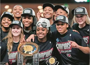  ?? DWAYNE MCLEMORE/THE STATE/TNS ?? South Carolina celebrates Sunday’s SEC tournament championsh­ip win at Bon Secours Wellness Arena in Greenville, South Carolina on March 5.