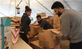  ?? The Guardian ?? Fareeha Haq , Muhammad Arif and Faizan Syed Maqsood of the Council of Peoples Organizati­on work to sort donations to Pakistan flood victims. Photograph: Wilfred Chan/