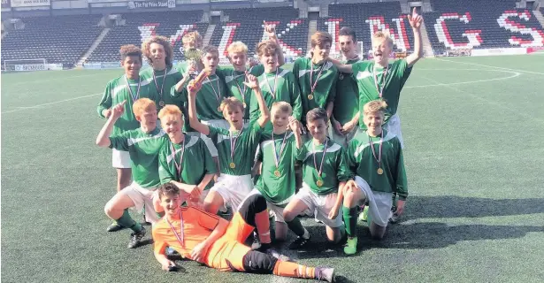  ??  ?? Helsby High School’s Year 9 football team celebrate defeating Ormiston Chadwick 6-0 to win the Halton Cup in a match played at the Select Security Stadium in Widnes. The team also reached the last 32 in the country beating Merseyside champions SFX...