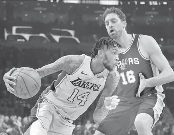  ?? Jae C. Hong Associated Press ?? BRANDON INGRAM of the Lakers drives past Pau Gasol of the Spurs in the first half. Lakers coach Luke Walton believes that Gasol’s number one day will be retired by the organizati­on.