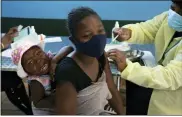  ?? DENIS FARRELL — THE ASSOCIATED PRESS FILE ?? A baby cries as her mother receives her Pfizer vaccine against COVID-19, in Diepsloot Township near Johannesbu­rg Thursday, Oct. 21.