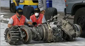  ?? ACHMAD IBRAHIM — THE ASSOCIATED PRESS FILE ?? In this file photo officials inspect an engine recovered from the crashed Lion Air jet in Jakarta, Indonesia. On the anniversar­y of the first crash of a Boeing 737 Max, the CEO will begin two days of testimony before Congress by telling lawmakers that the aircraft company knows it made mistakes and is throwing everything into fixing the plane.