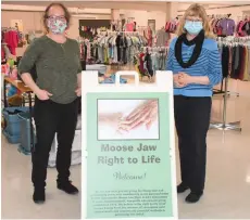  ??  ?? Moose Jaw Right to Life’s Amy Pryadko (left) and Jean Landry, president, gather in the new Right to Life Centre in the basement of First Baptist Church at 1010 Main Street. The new location gives more space for more racks to display baby and children’s clothing. (Photo by Jason G. Antonio)