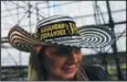  ?? (File Photo/AP/Ariana Cubillos) ?? A fan wears a traditiona­l Colombian hat with the names of Fernandez and Uribe on March 3 as she lines up to attend their concert in Caracas.