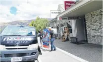  ?? PHOTO: KERRIE WATERWORTH ?? Domestic tourists not enough . . . Skydive Wanaka pilot Hamish Brown and Business Developmen­t Manager Derek Melnick (right) remove a Skydiving Wanaka billboard from Base Backpacker­s Wanaka.