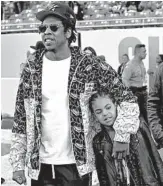  ?? DAVID J. PHILLIP/AP ?? Halftime show producer Jay-Z and daughter Blue Ivy check out the field before the Super Bowl game Sunday.